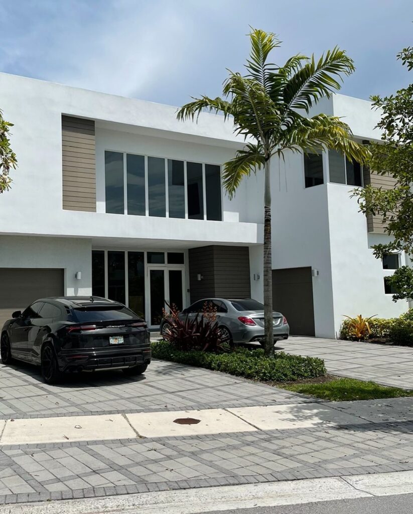 Facade of LamboRaul's Miami home with his vehicles parked on the drive way.