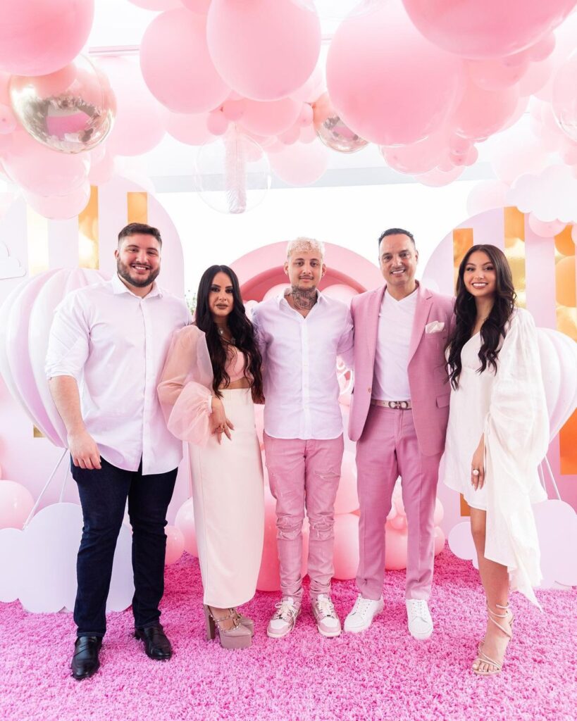 LamboRaul with his siblings and parents in a pink & white-themed background.