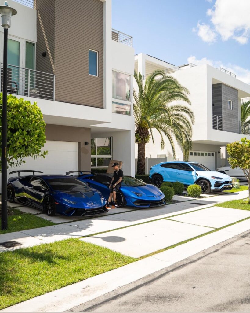 LamboRaul sitting on his Aventador with his Ferrari SF90 and Rolls Royce Cullinan in sight front of his Miami home.